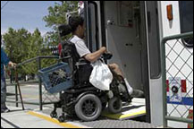 image of person in wheelchair boarding trax