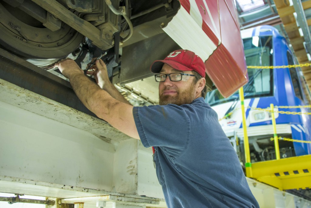 Electromechanic Dave Wright works on the sand nozzle, which pours sand on the rail in front of the TRAX wheel when extra traction is needed. 